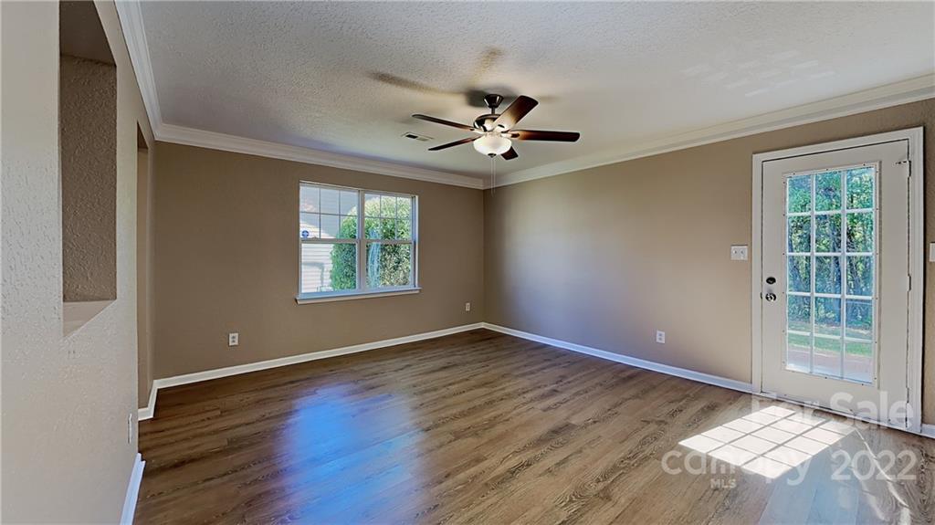 701 Raindrops Road Gastonia, NC 28054 - Photo 13 of 14 a view of an empty room with window and wooden floor