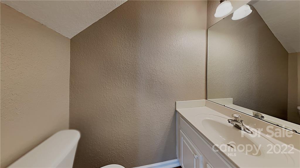 701 Raindrops Road Gastonia, NC 28054 - Photo 10 of 14 a bathroom with a granite countertop sink and a mirror