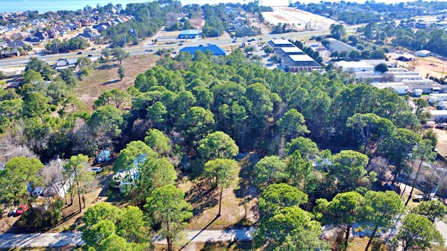 an aerial view of residential house with outdoor space and trees all around