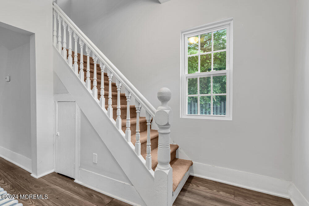 57 Jackson Street Freehold, NJ 07728 - Photo 11 of 48 a view of staircase with wooden floor and white walls