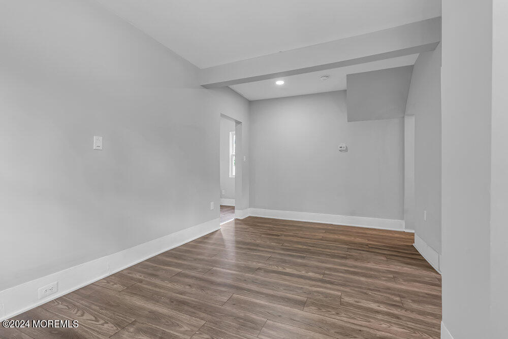57 Jackson Street Freehold, NJ 07728 - Photo 13 of 48 a view of an empty room with wooden floor