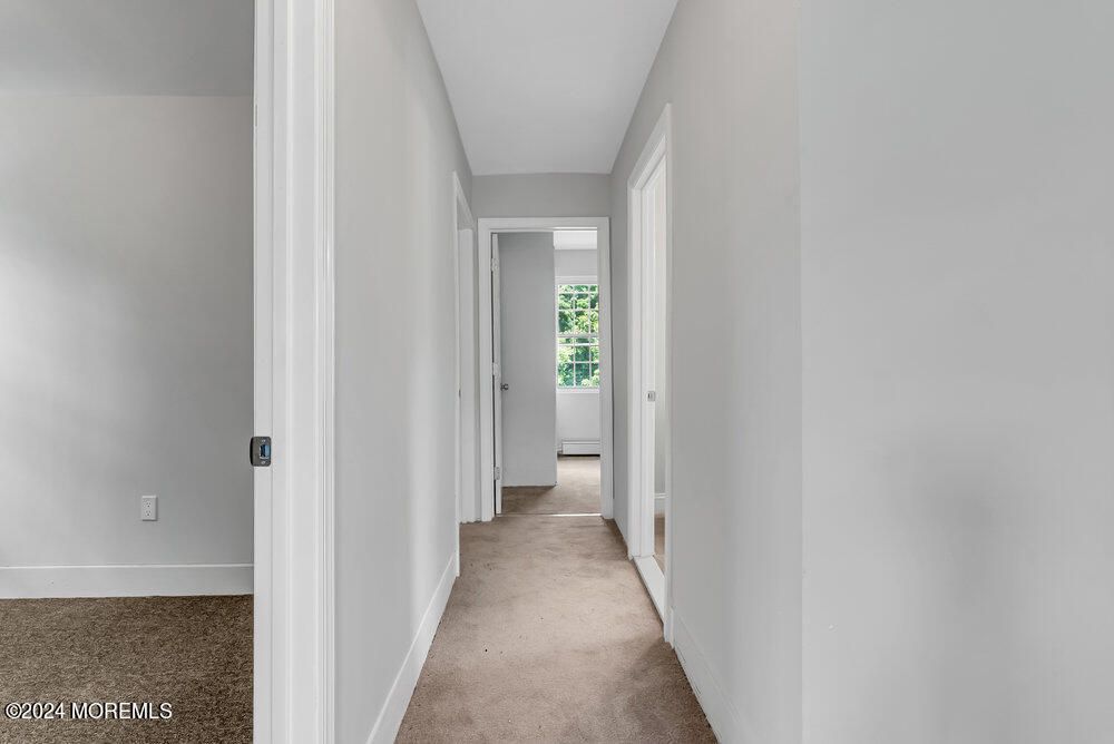 57 Jackson Street Freehold, NJ 07728 - Photo 38 of 48 a view of a hallway with wooden floor and a bathroom