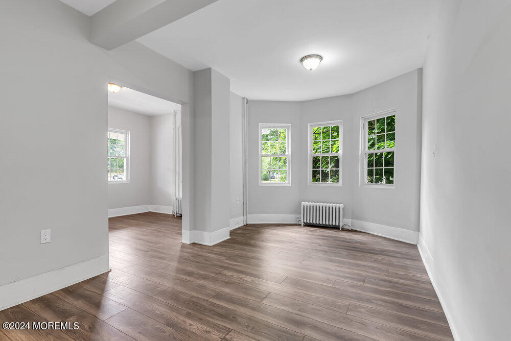 57 Jackson Street Freehold, NJ 07728 - Photo 10 of 48 an empty room with wooden floor and windows