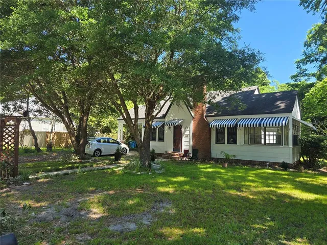 a front view of house with yard and trees