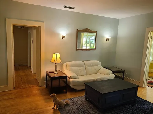 a living room with furniture and a lamp
