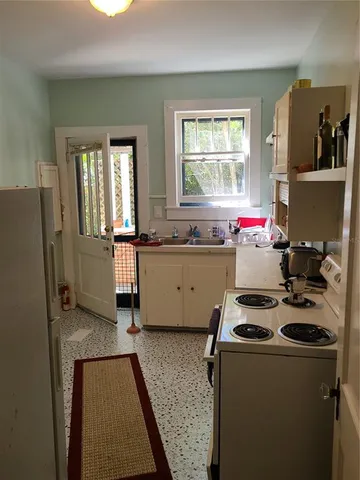 a kitchen that has a sink and a stove in it