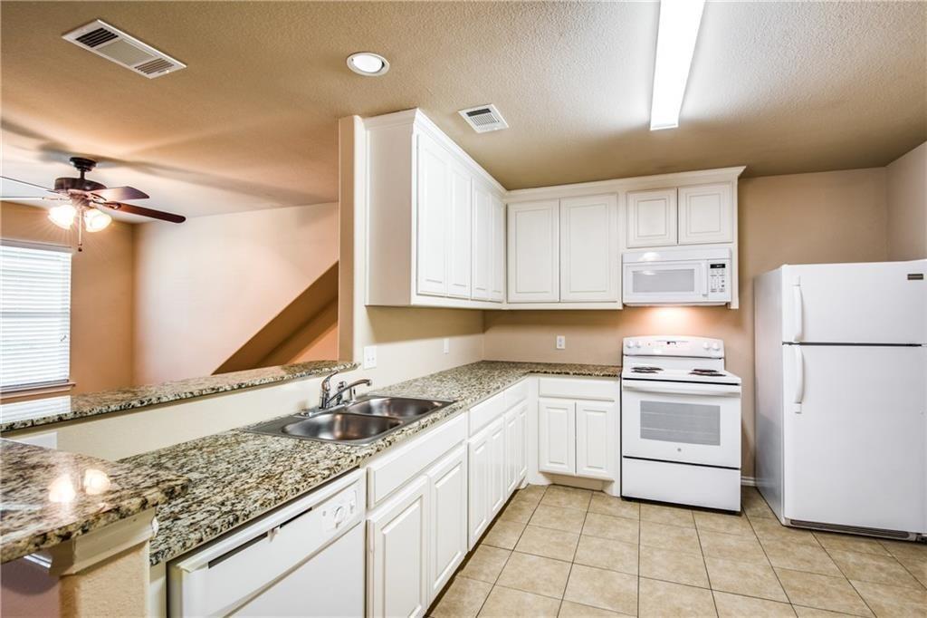 6452 Gregg Road Krum, TX 76249 - Photo 2 of 10 Kitchen featuring white appliances, white cabinetry, a ceiling fan, light stone counters, and a textured ceiling