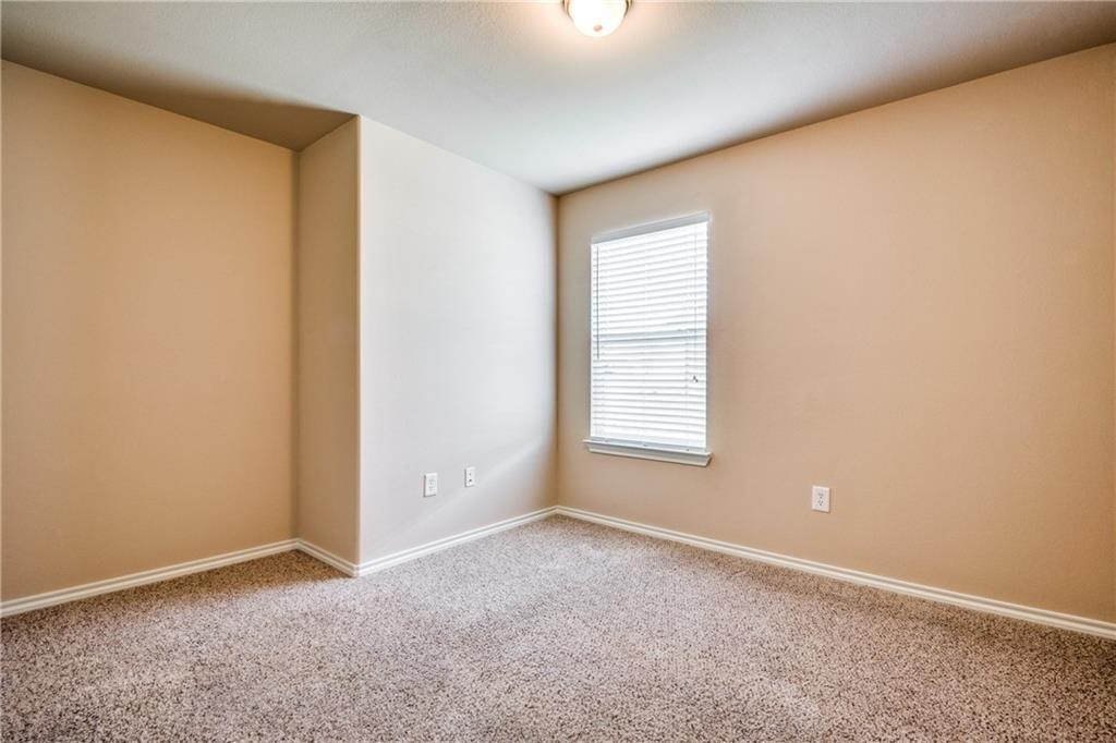6452 Gregg Road Krum, TX 76249 - Photo 8 of 10 Carpeted spare room featuring baseboards
