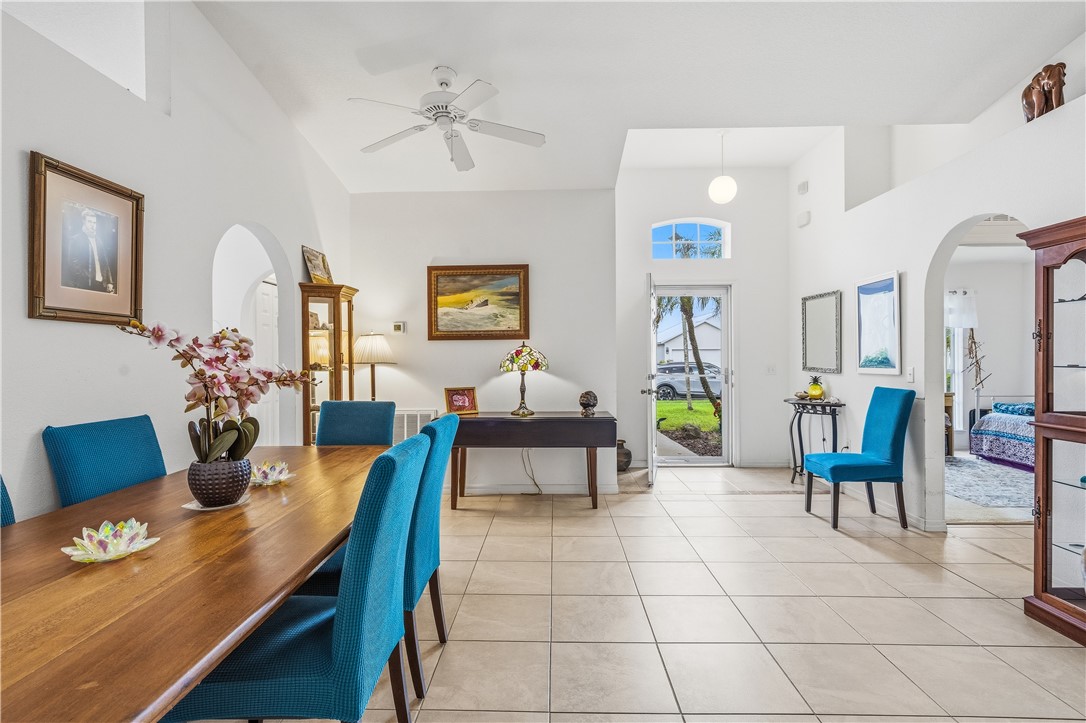 131 Bellamy Trail Sebastian, FL 32958 - Photo 8 of 32 a living room with furniture a chandelier and a dining table
