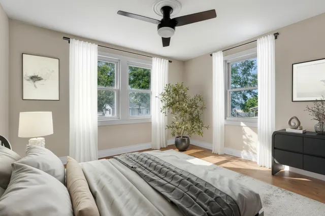 a bedroom with a large bed and a chandelier