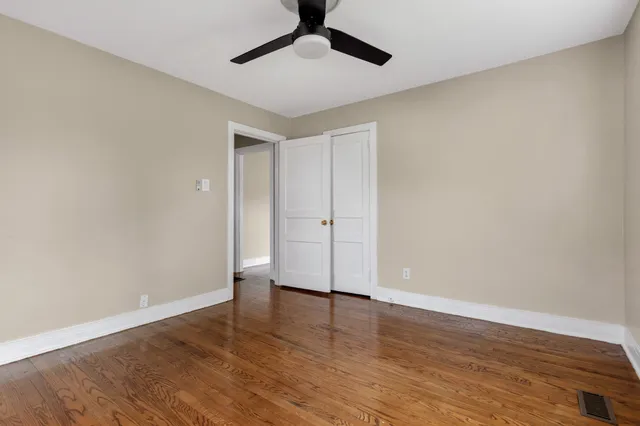 a view of room with window and wooden floor