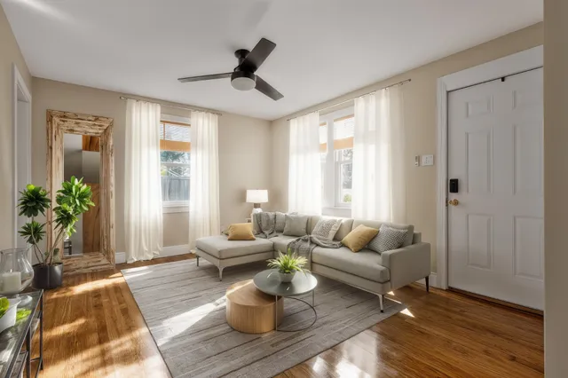 a view of empty room with wooden floor and window