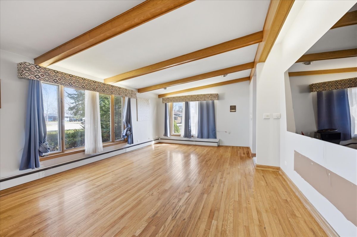616 Seneca Drive Aurora, IL 60506 - Photo 11 of 36 a view of an empty room with wooden floor and a window