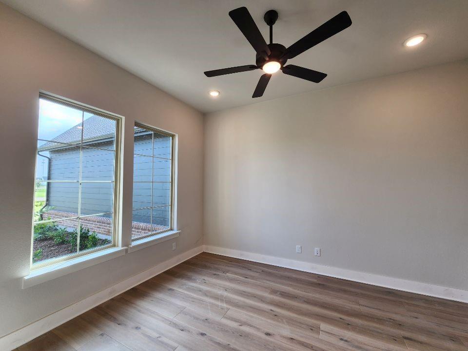 2305 Gypsum Street Krum, TX 76249 - Photo 6 of 22 Room featuring dual windows with grid patterns, recessed lighting, and a black ceiling fan