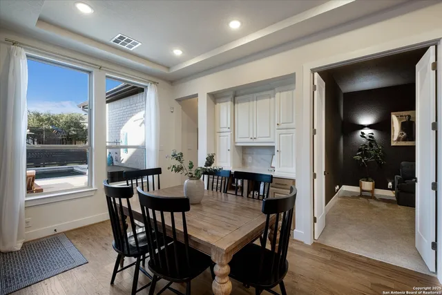 a view of a dining room with furniture and window