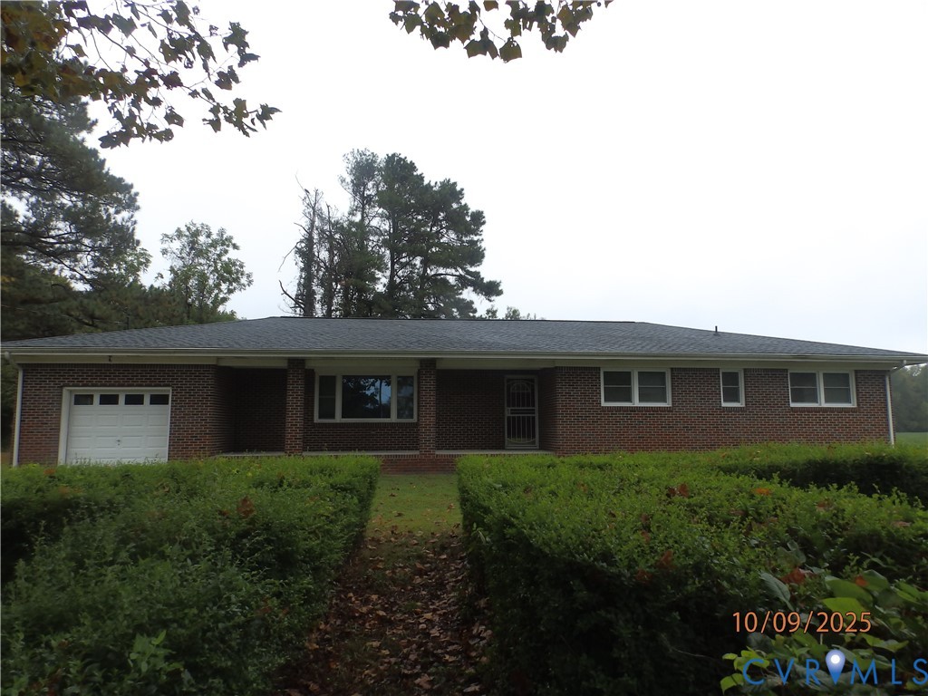a front view of house with a garden