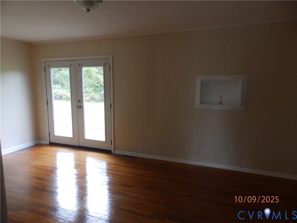 860 Lebanon Road Spring Grove, VA 23881 - Photo 11 of 32 a view of an empty room with wooden floor and a window