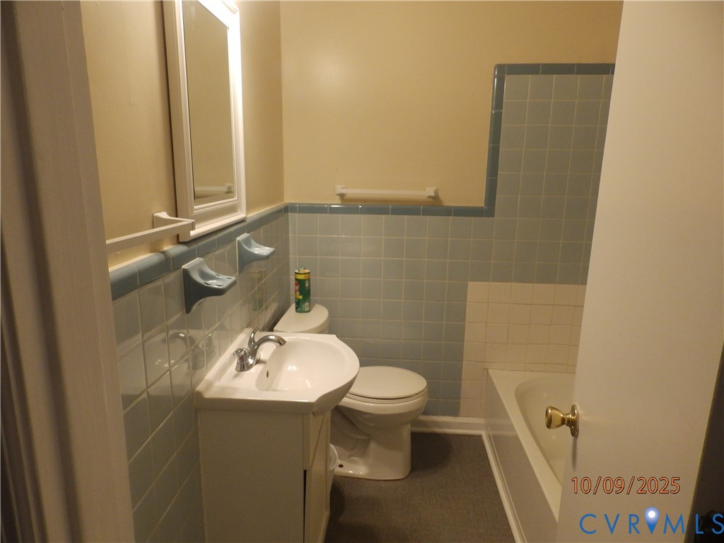 860 Lebanon Road Spring Grove, VA 23881 - Photo 14 of 32 a bathroom with a sink a toilet and mirror