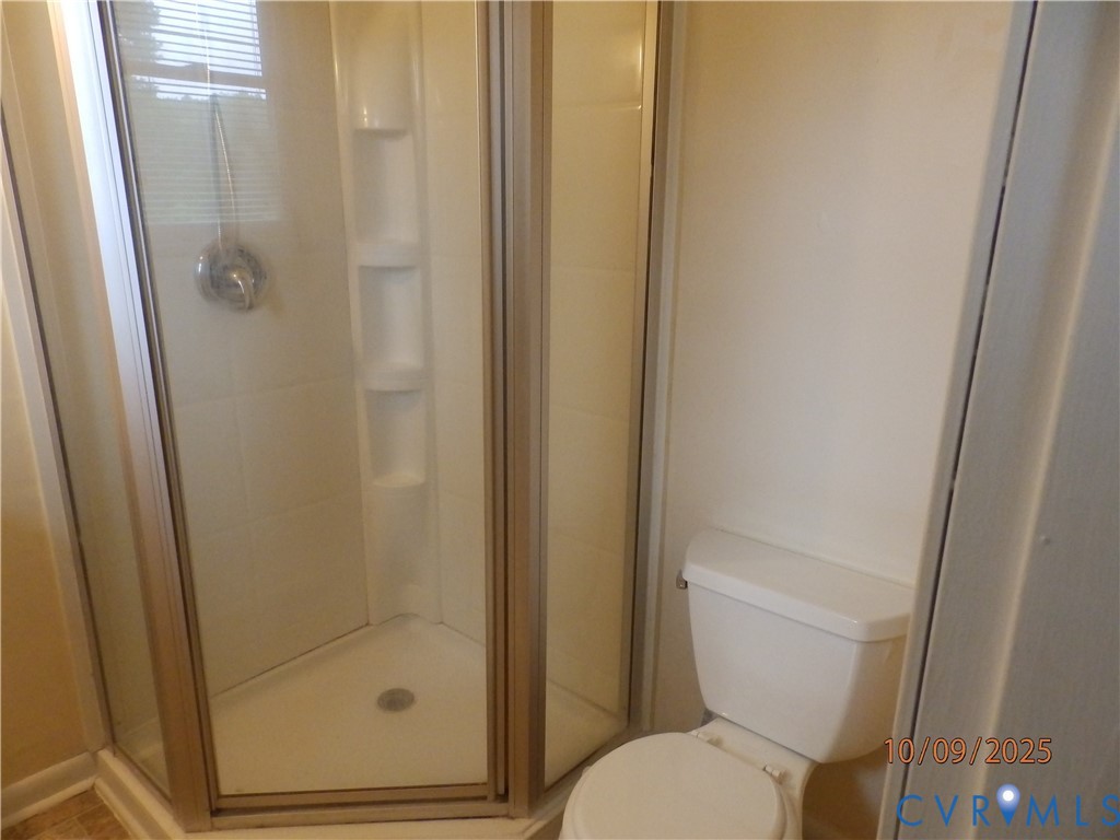 860 Lebanon Road Spring Grove, VA 23881 - Photo 16 of 32 a white toilet sitting next to a shower