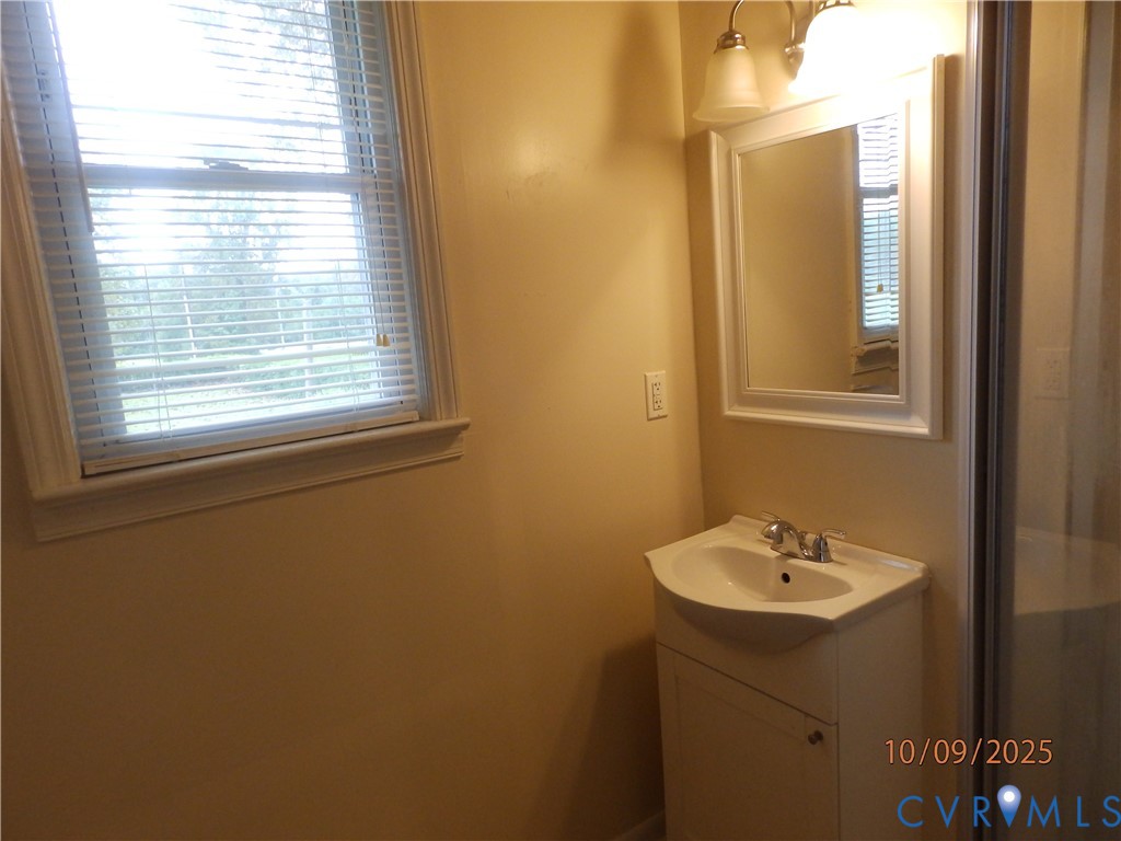 860 Lebanon Road Spring Grove, VA 23881 - Photo 17 of 32 a bathroom with a sink a mirror and a window