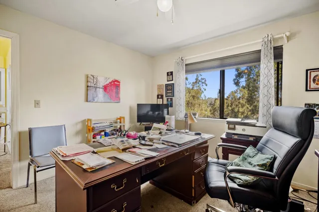 a view of a workspace with furniture window and outside view