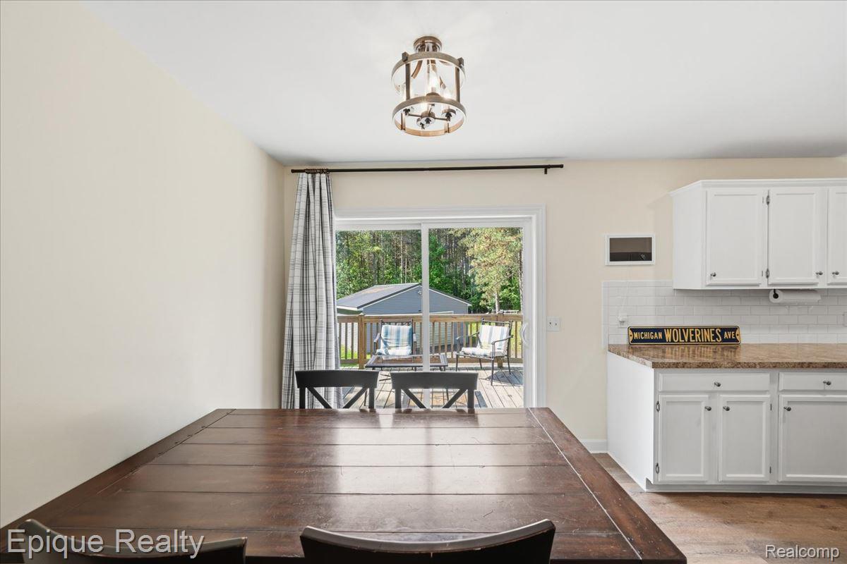 12272 East Mt Morris Road Davison, MI 48423 - Photo 8 of 39 Bright dining area featuring a wood-finish dining table and a bronze-tone drum pendant light