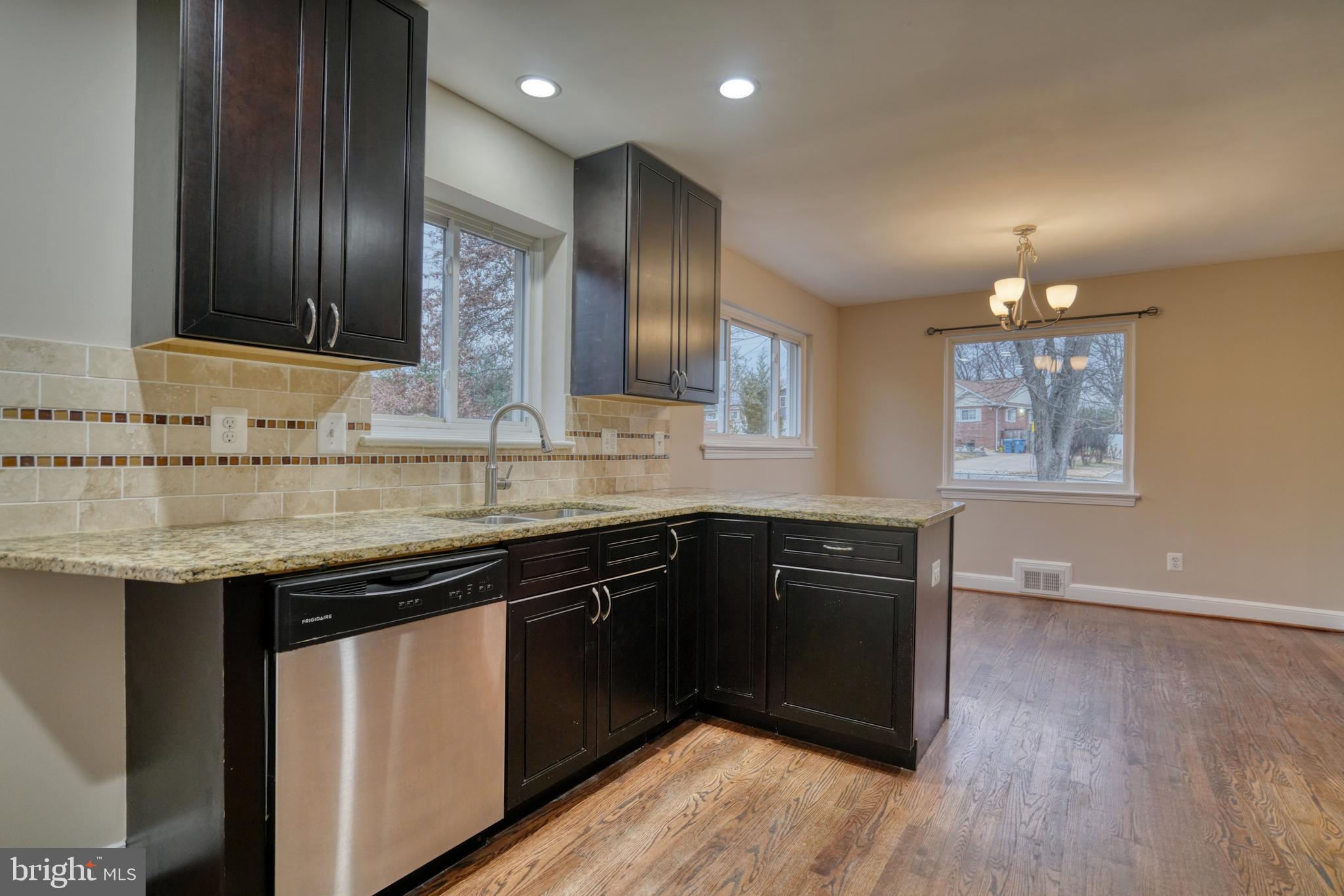 6000 Grayson Street Springfield, VA 22150 - Photo 11 of 37 a kitchen with a sink stove and cabinets