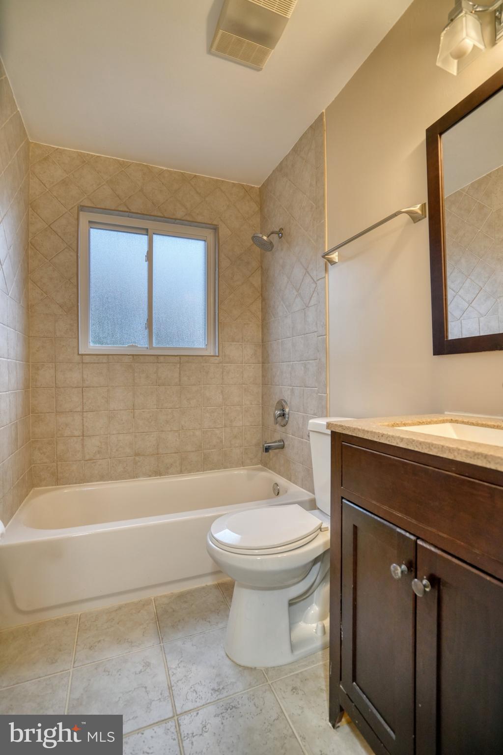 6000 Grayson Street Springfield, VA 22150 - Photo 15 of 37 a bathroom with a sink a toilet and bathtub