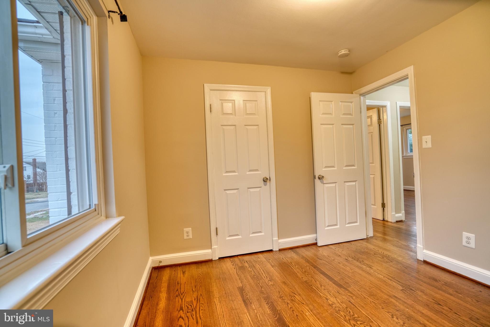 6000 Grayson Street Springfield, VA 22150 - Photo 23 of 37 a view of an empty room with wooden floor and a window