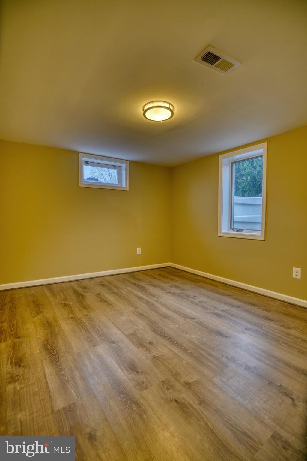 6000 Grayson Street Springfield, VA 22150 - Photo 27 of 37 a view of an empty room with wooden floor and a window