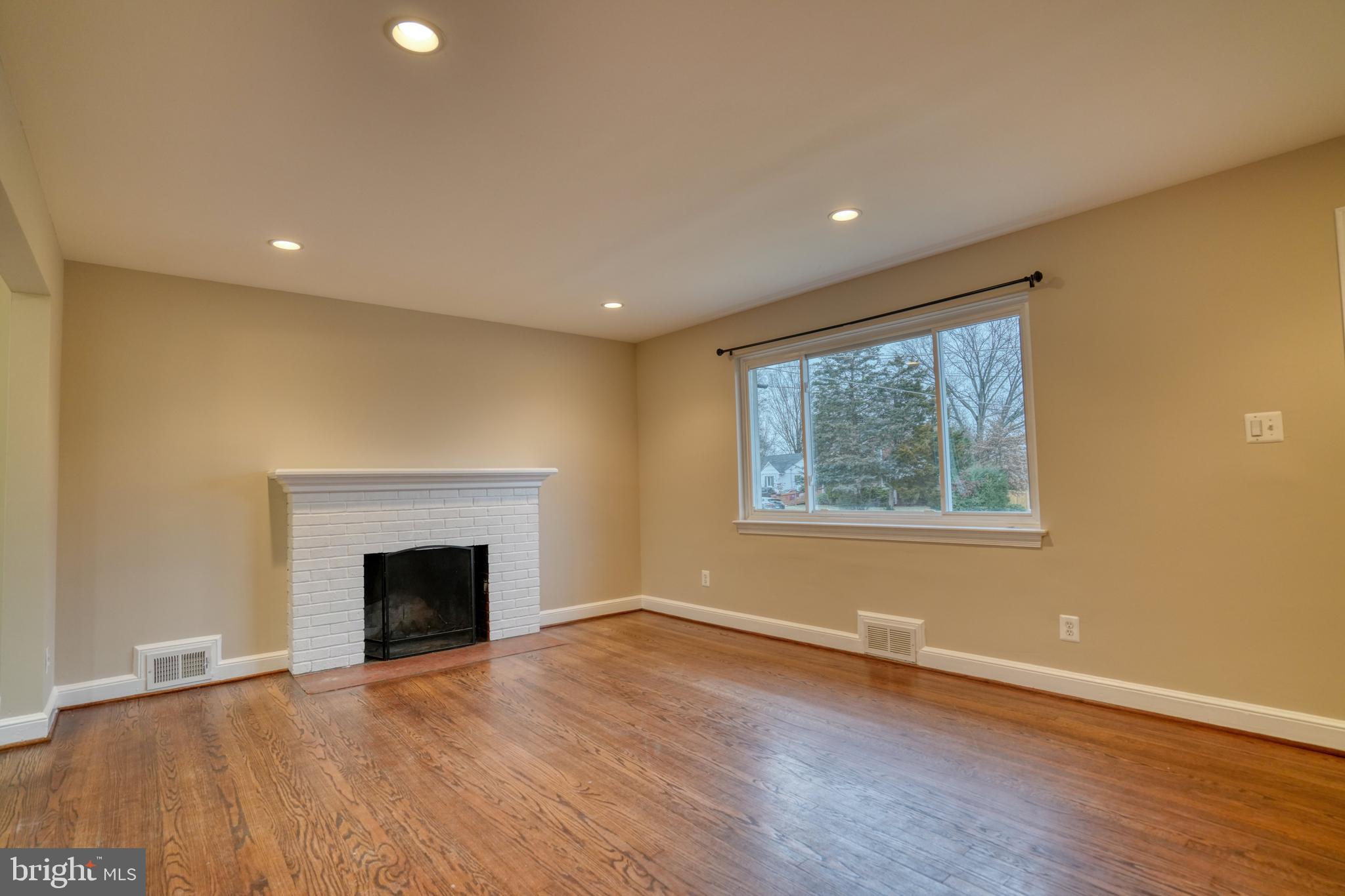 6000 Grayson Street Springfield, VA 22150 - Photo 3 of 37 a view of empty room with wooden floor and fireplace