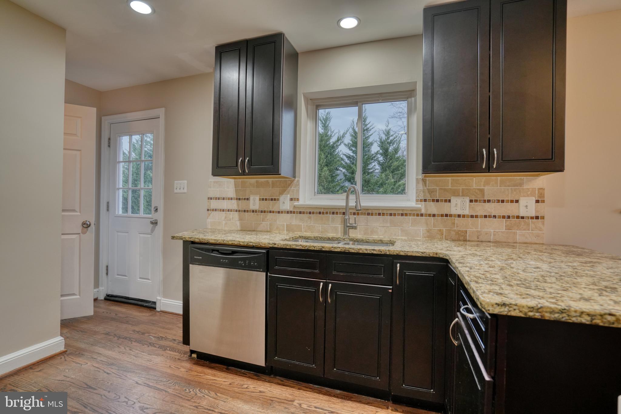 6000 Grayson Street Springfield, VA 22150 - Photo 8 of 37 a sink with granite countertop cabinets and window