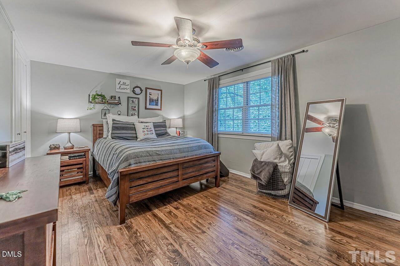 1037 St Marys Street, Unit 1037 Raleigh, NC 27605 - Photo 28 of 36 a bedroom with a bed and wooden floor