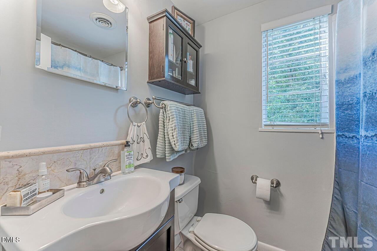 1037 St Marys Street, Unit 1037 Raleigh, NC 27605 - Photo 29 of 36 a bathroom with a sink and a mirror