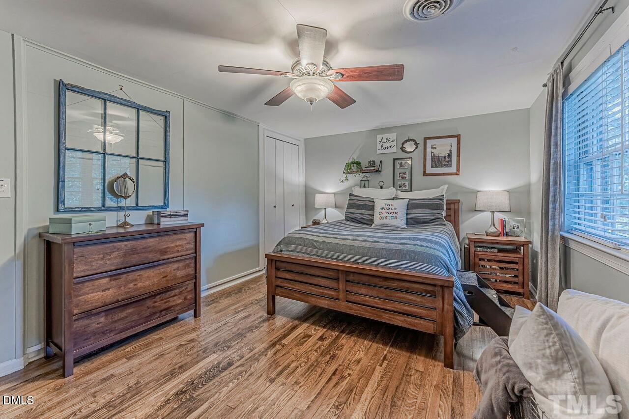 1037 St Marys Street, Unit 1037 Raleigh, NC 27605 - Photo 30 of 36 a bedroom with a bed and wooden floor