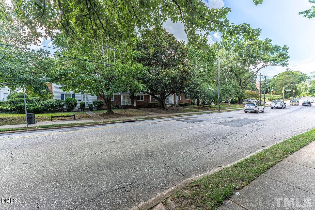 1037 St Marys Street, Unit 1037 Raleigh, NC 27605 - Photo 3 of 36 a front view of a building with trees and cars