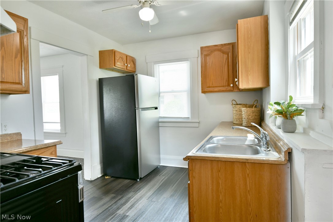 3617 South Main Street Mineral Ridge, OH 44440 - Photo 15 of 34 Kitchen featuring stainless steel refrigerator, sink, dark hardwood / wood-style flooring, and ceiling fan