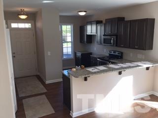 844 Horton Road, Unit 51 Durham, NC 27704 - Photo 2 of 13 a kitchen with stainless steel appliances granite countertop a sink stove and refrigerator