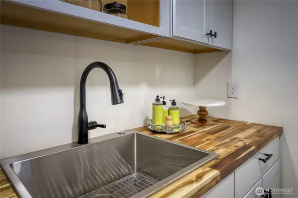 a kitchen with a stove a sink and a window
