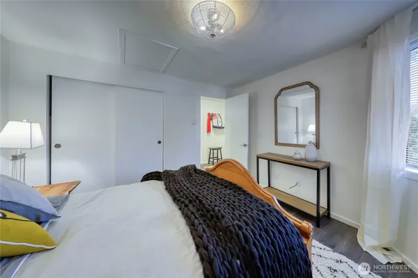 a view of a hallway with furniture and wooden floor