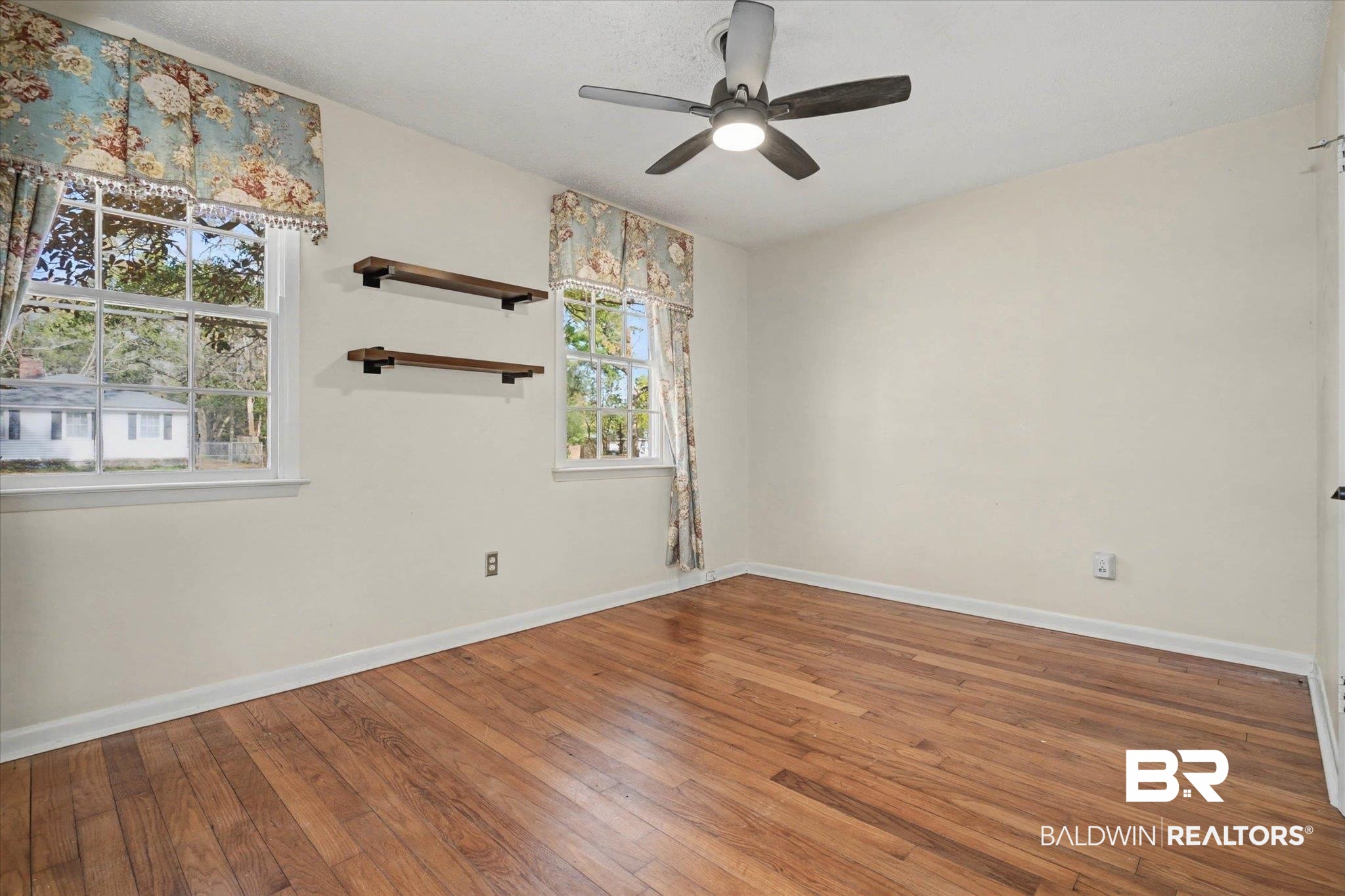5117 Norton Lane Mobile, AL 36608 - Photo 14 of 35 Empty room featuring wood-type flooring and a ceiling fan