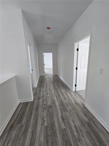 a view of a room with wooden floor and white doors