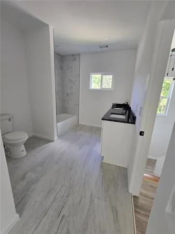 a view of a kitchen cabinets and a wooden floor