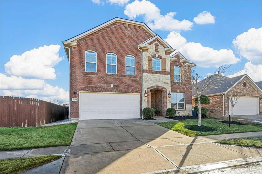 14815 Frisco Ranch Drive Little Elm, TX 75068 - Photo 2 of 40 a view of a brick house with a yard