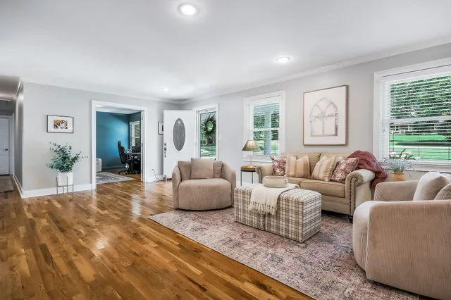 a kitchen with granite countertop a table chairs refrigerator and cabinets