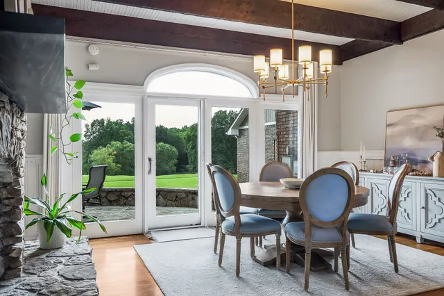 a spacious bedroom with a bed and wooden floor