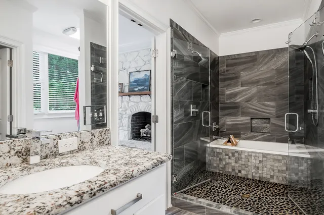 a spacious bathroom with a granite countertop toilet sink and a mirror