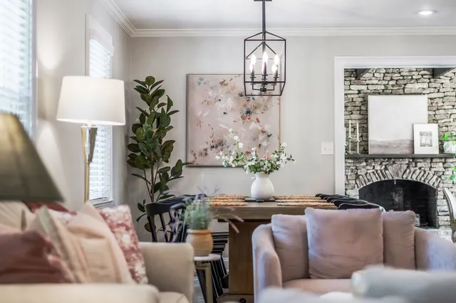 a view of a house with a yard and large tree