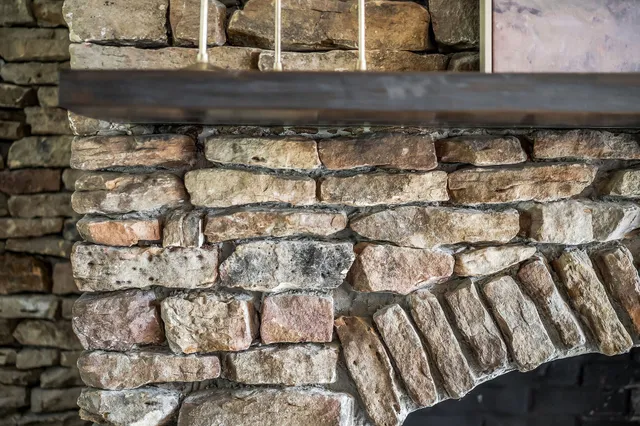 a front view of a house with a garden and trees