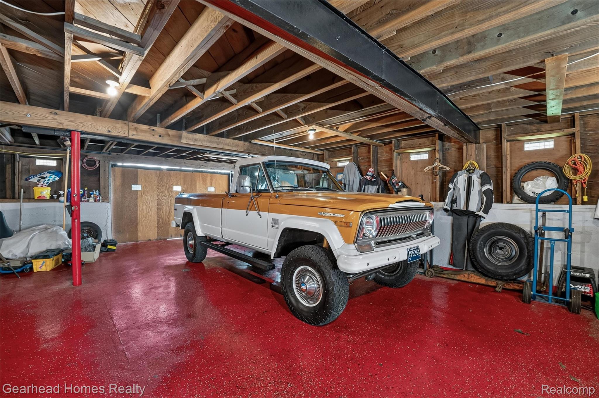 3486 West Drahner Road Oxford, MI 48371 - Photo 33 of 51 Basement featuring exposed wood beam ceiling, red-painted concrete flooring, and built-in storage areas